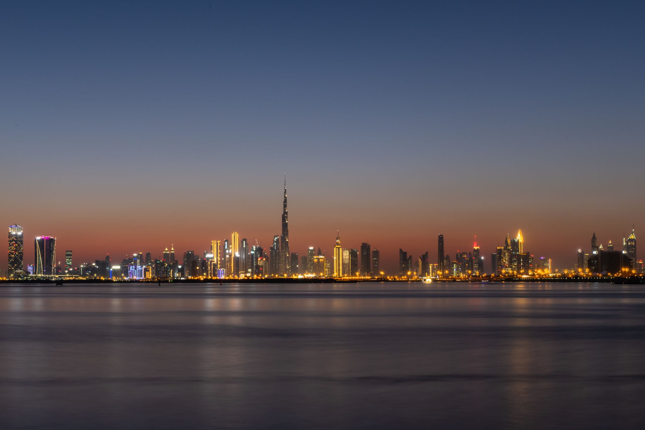 A city skyline illuminated after dark